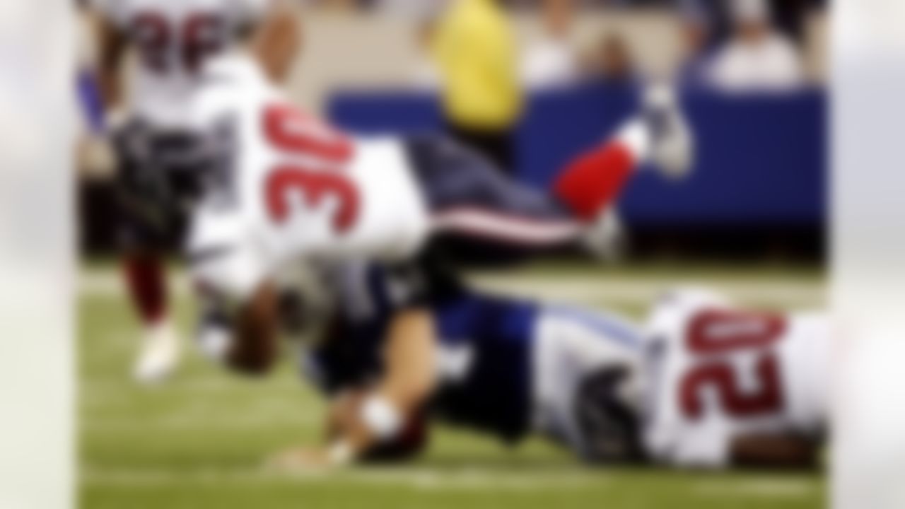 INDIANAPOLIS - SEPTEMBER 17:  Tight end Dallas Clark #44 of the Indianapolis Colts is tackled by safety Jason Simmons #30 of the Houston Texans during the game on September 17, 2006 at the RCA Dome in Indianapolis, Indiana. The Colts won 43-24. Photo by Getty Images.