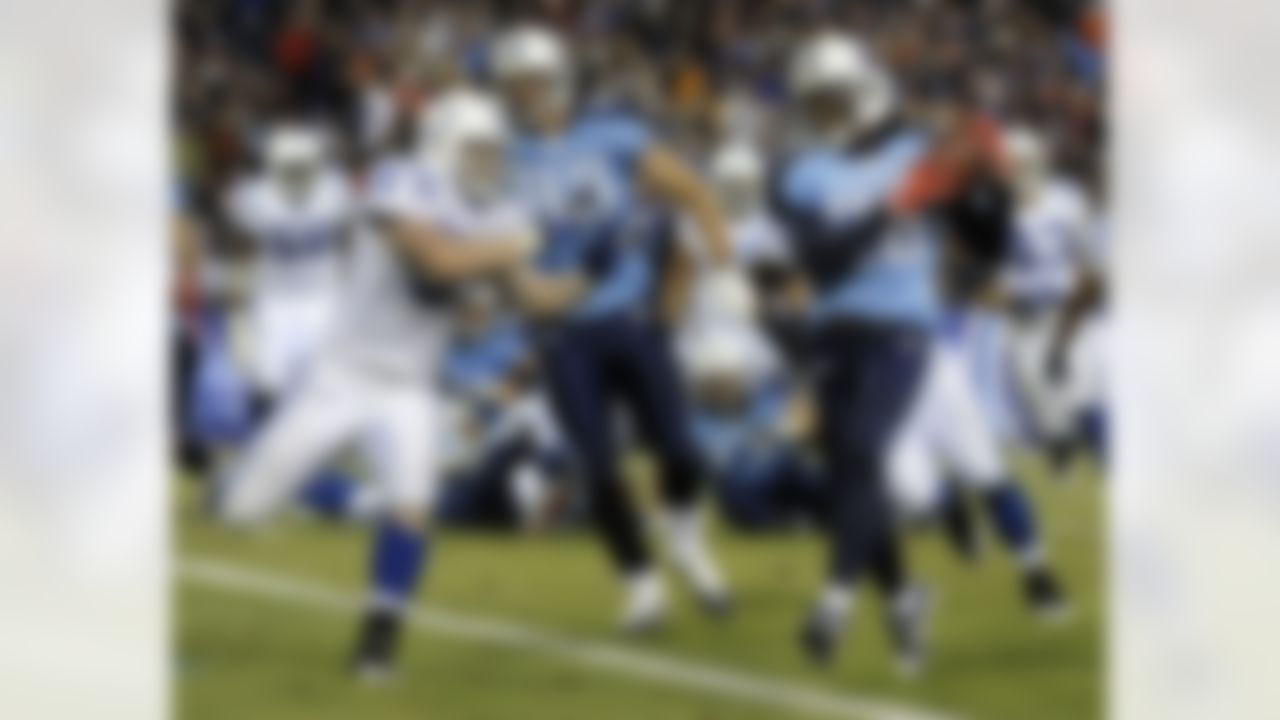 Tennessee Titans running back Chris Johnson (28) protects the ball from Indianapolis Colts linebacker Pat Angerer (51) as Johnson crosses the goal line to score a touchdown on a 1-yard touchdown run in the second quarter of an NFL football game on Thursday, Dec. 9, 2010, in Nashville, Tenn. (AP Photo/Joe Howell)