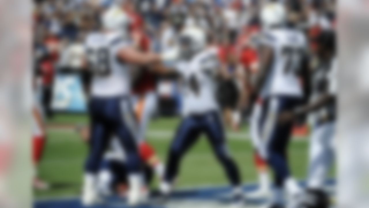 San Diego Chargers running back Ryan Mathews, center, celebrates with teammates  Kris Dielman, left, and  Marcus McNeill after scoring a touchdown against the Kansas City Chiefs in the first half of an NFL football game  Sunday, Sept. 25, 2011, in San Diego. (AP Photo/Denis Poroy)