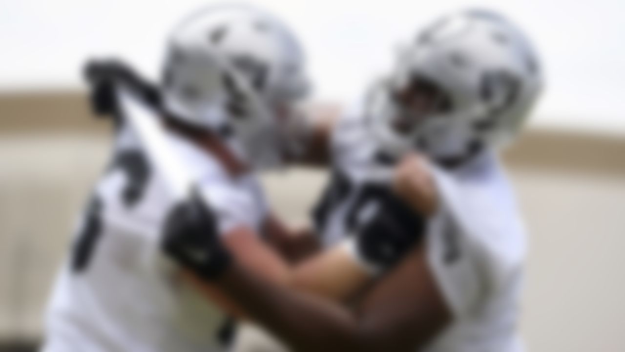 Las Vegas Raiders center Nick Martin, left, and tackle Brandon Parker perform a drill during an NFL football organized team activity at the team's training facility Wednesday, May 26, 2021, in Henderson, Nev.