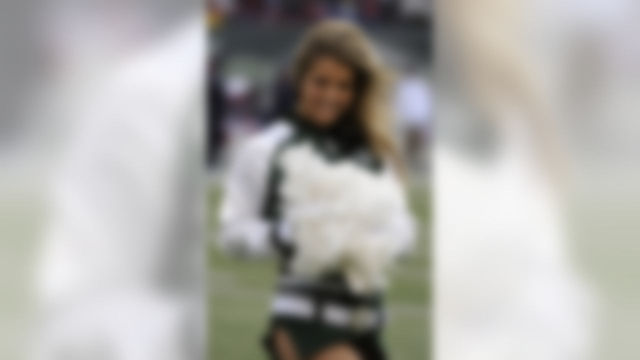 A New York Jets cheerleader looks on during the first quarter of an NFL football game against the Buffalo Bills Sunday, Oct. 18, 2009  in East Rutherford, N.J.  (AP Photo/Bill Kostroun)