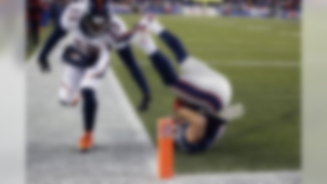 New England Patriots wide receiver Julian Edelman, right, lands in the end zone with a touchdown catch alongside Denver Broncos cornerback Quentin Jammer in the third quarter of an NFL football game Sunday, Nov. 24, 2013, in Foxborough, Mass. (AP Photo/Elise Amendola)