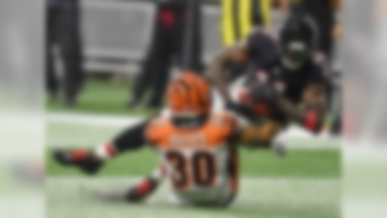 Atlanta Falcons wide receiver Julio Jones (11) is hit by Cincinnati Bengals defensive back Jessie Bates (30) during the first half of an NFL football game, Sunday, Sept. 30, 2018, in Atlanta. (AP Photo/John Amis)