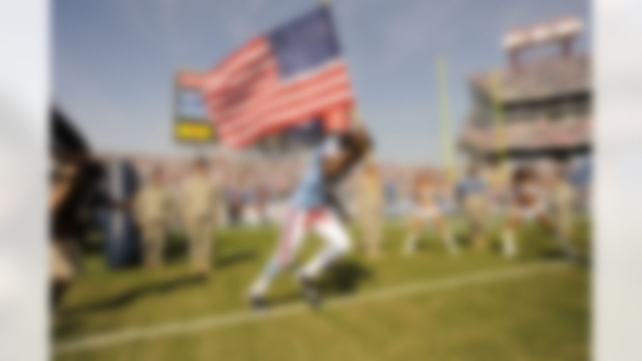 Tennessee Titans running back Chris Johnson carries a flag as he runs onto the field before an NFL football game against the Buffalo Bills in Nashville, Tenn., Sunday, Nov. 15, 2009. (AP Photo/John Russell)