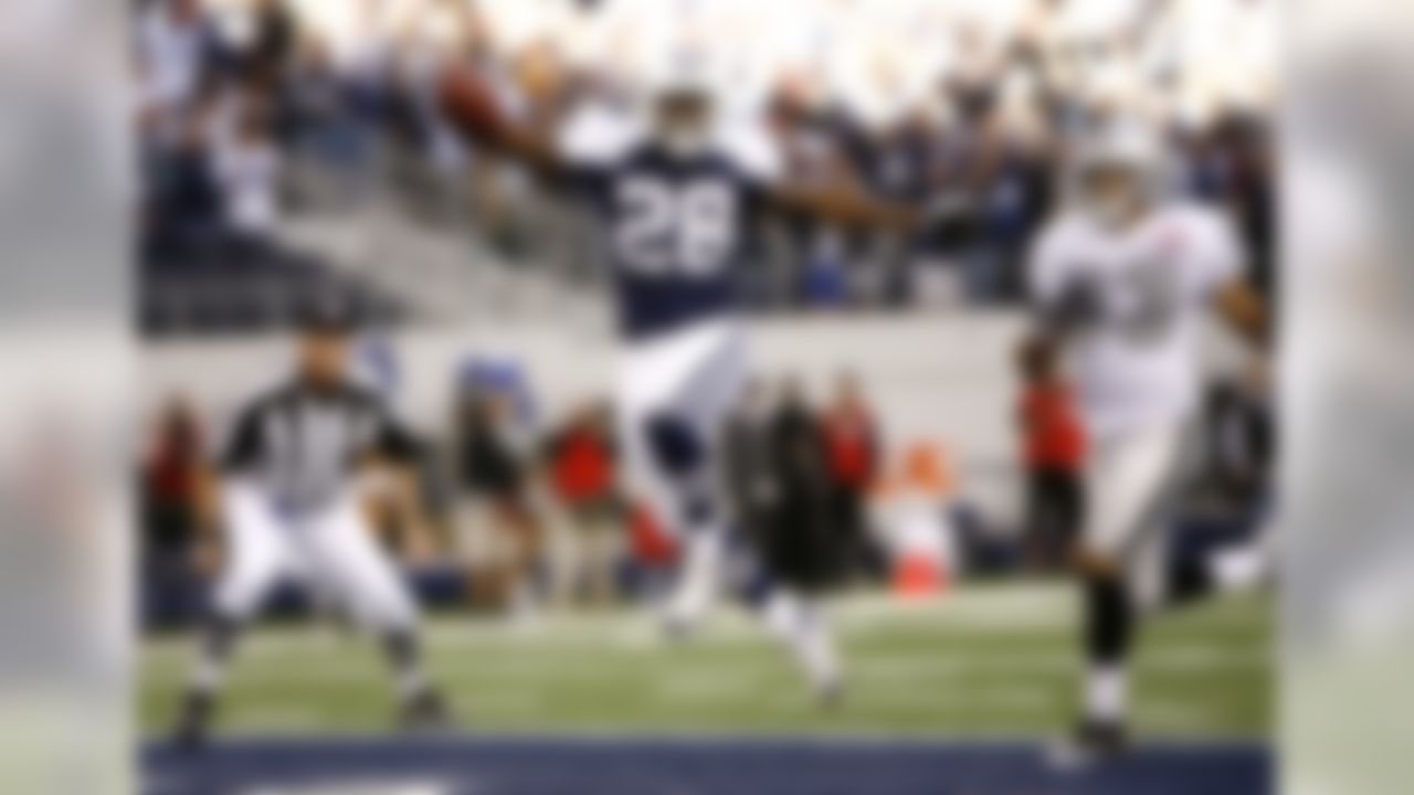 Oakland Raiders cornerback Tyvon Branch (33) and an official look on as Dallas Cowboys running back Felix Jones (28) leaps into the end zone for a touchdown in the first half of an NFL football game, Thursday, Nov. 26, 2009, in Arlington, Texas. (AP Photo/Erich Schlegel)