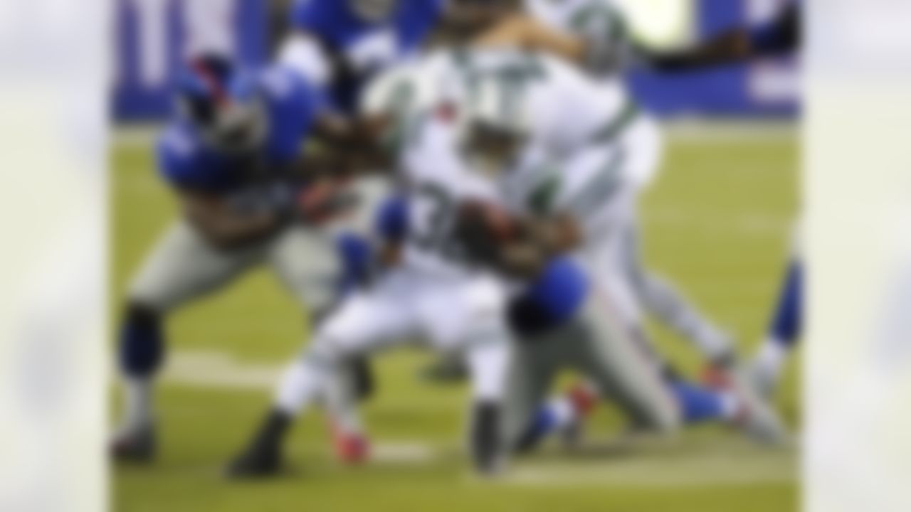 New York Jets running back Zac Stacy (38) is tackled by New York Giants' Owamagbe Odighizuwa (58) and Devon Kennard during the first half of a preseason NFL football game Saturday, Aug. 29, 2015, in East Rutherford, N.J. (AP Photo/Bill Kostroun)