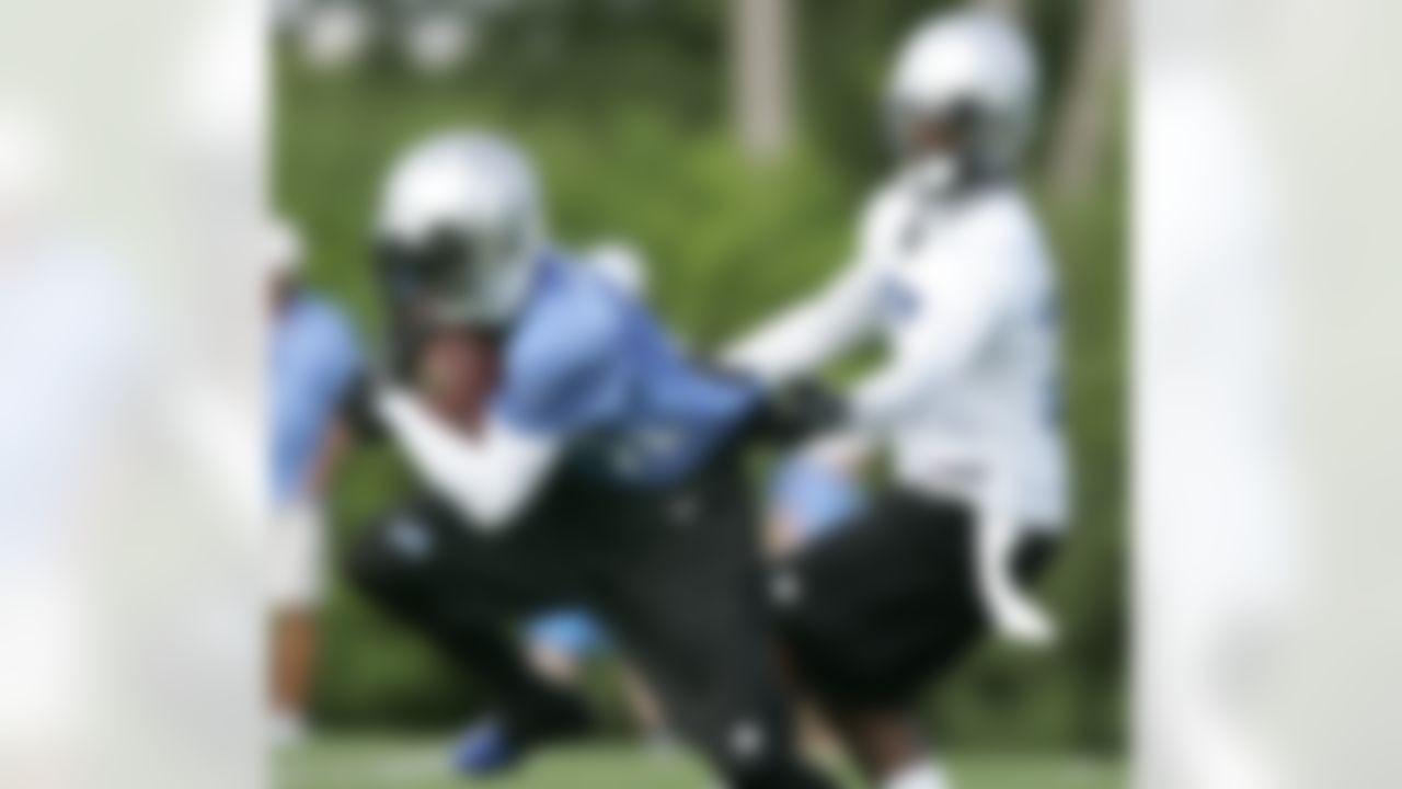 Detroit Lions wide receiver Titus Young is held by cornerback Alphonso Smith, right, during NFL football training camp Saturday, July 28, 2012, in Allen Park, Mich. (AP Photo/Duane Burleson)