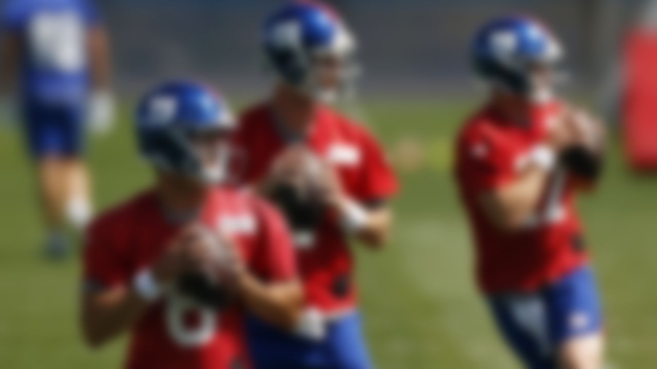 New York Giants quarterback Daniel Jones, left, throws during NFL football practice in East Rutherford, N.J., Thursday, May 27, 2021.