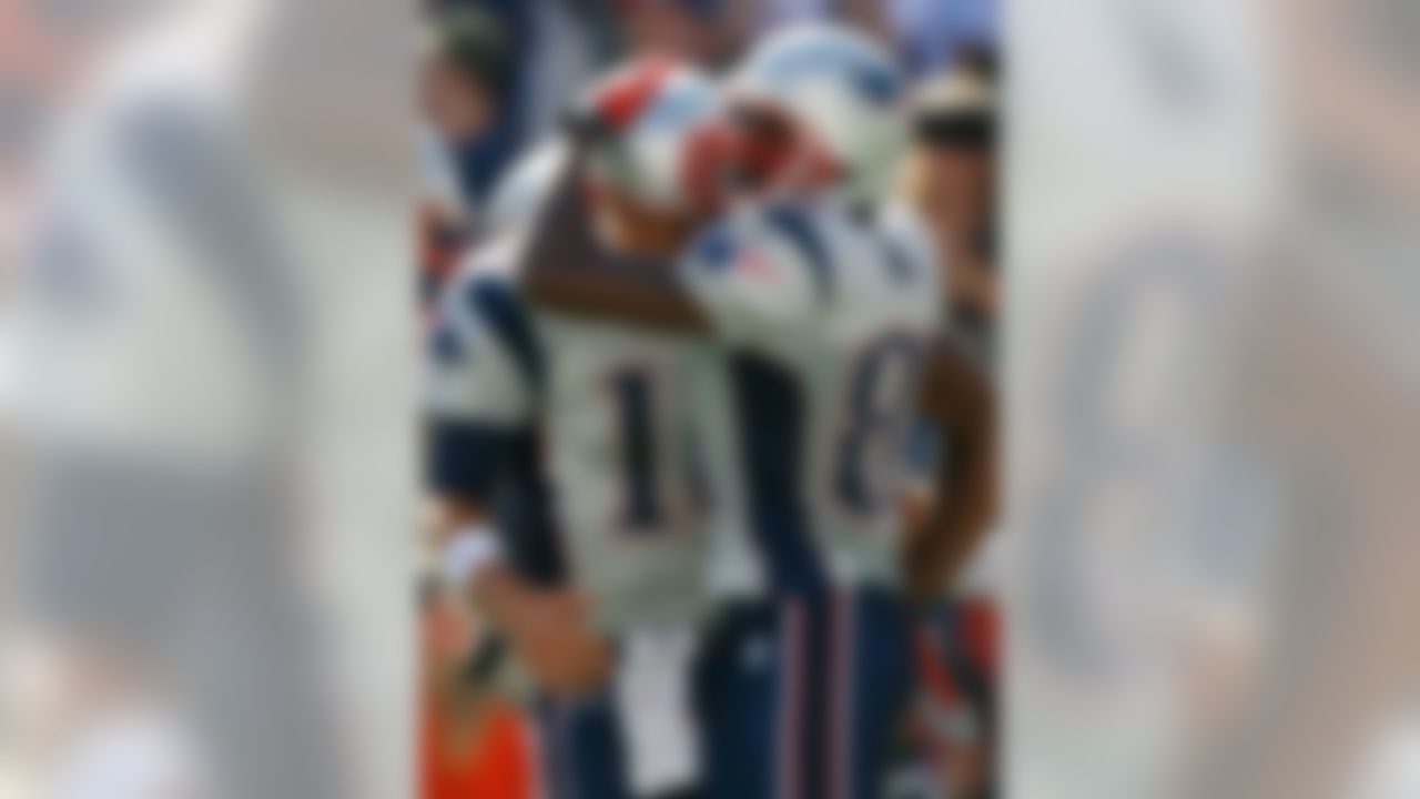 FOXBORO, MA - SEPTEMBER 23:  Randy Moss #18 and Tom Brady #12 of the New England Patriots celebrate a touchdown by Jabar Gaffney during a game against the Buffalo Bills at Gillette Stadium on September 23, 2007 in Foxboro, Massachusetts. The Patriots defeated the Bills 38-7.  (Photo by Jim Rogash/Getty Images)