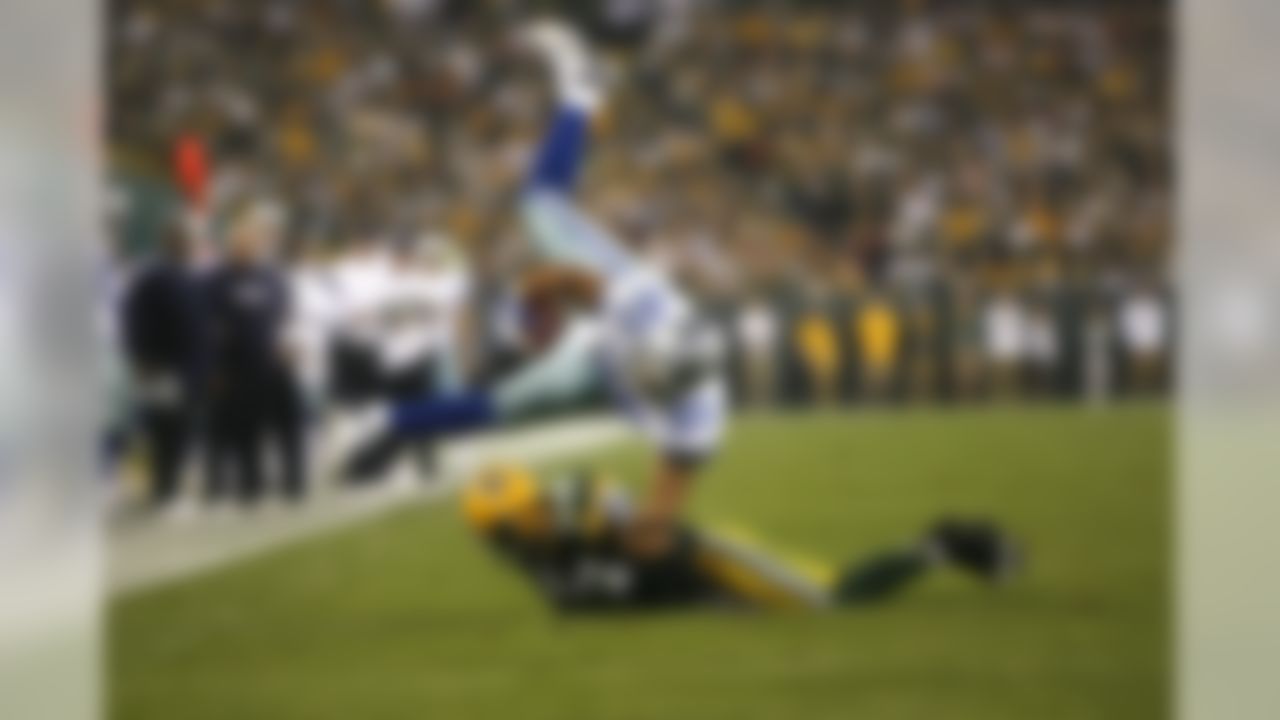 GREEN BAY - SEPTEMBER 21:  Tony Curtis #89 of the Dallas Cowboys is tackled by Brandon Chillar #54 against the Green  Bay Packers during the first half of their game at Lambeau Field on September 21, 2008 in Green Bay, Wisconsin.  (Photo by Tom Hauck/Getty Images)