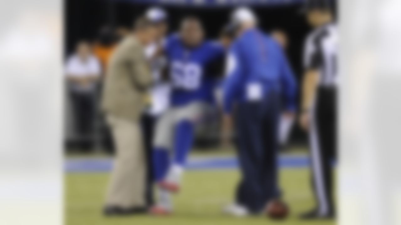 New York Giants offensive guard Bobby Hart (68) is helped up by trainers after being hurt on a play during the second half of a preseason NFL football game against the New York Jets, Saturday, Aug. 29, 2015, in East Rutherford, N.J. (AP Photo/Bill Kostroun)