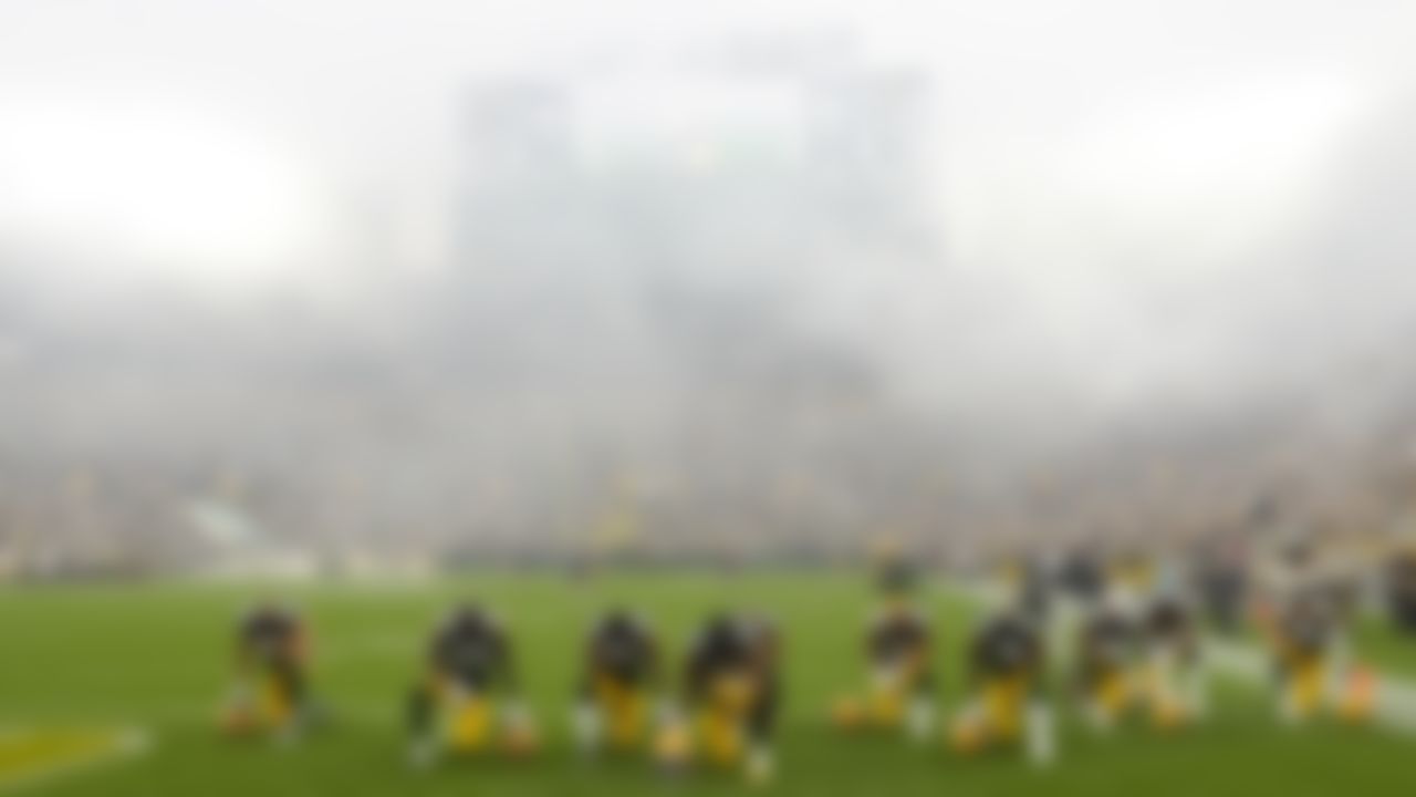 Green Bay Packers players take a knee before a game against the Pittsburgh Steelers at Lambeau Field on October 3, 2021 in Green Bay, Wisconsin.