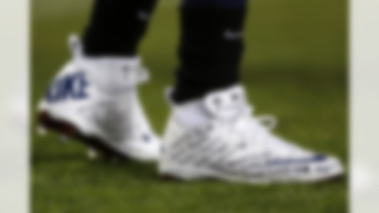 Tennessee Titans running back Chris Johnson wears a pair of shoes with the names of the victims of the Sandy Hook Elementary School shootings in Newtown, Conn., during warmups before an NFL football game against the New York Jets, Monday, Dec. 17, 2012, in Nashville, Tenn. (AP Photo/Joe Howell)