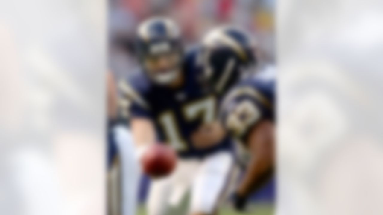 SAN DIEGO - JANUARY 2:  Quarterback Philip Rivers #17 of the San Diego Chargers hands the ball off to running back Michael Turner #33 during the game against the Kansas City Chiefs at Qualcomm Stadium on January 2, 2004 in San Diego, California. The Chargers defeated the Chiefs 24-17.  (Photo by Donald Miralle/Getty Images)