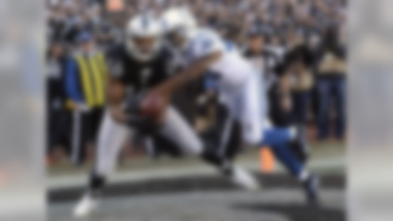 Oakland Raiders wide receiver Andre Holmes (18) catches a touchdown pass against Indianapolis Colts cornerback Rashaan Melvin (30) during the first half of an NFL football game in Oakland, Calif., Saturday, Dec. 24, 2016. (AP Photo/Marcio Jose Sanchez)