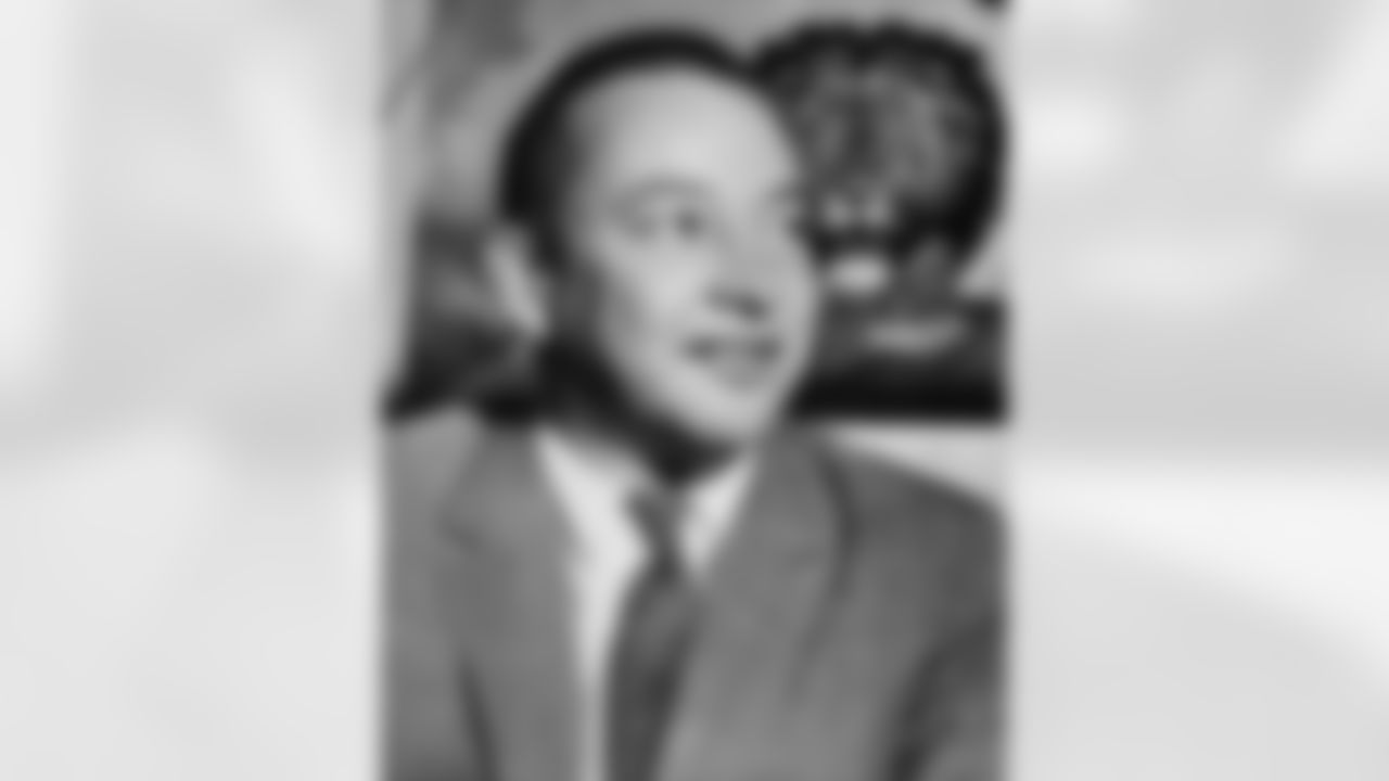 William Clay Ford poses in front of a lion drawing in the Detroit Lions office after officially taking over as president of the football club, Jan. 24, 1961. (Associated Press)