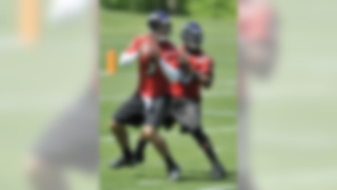 Baltimore Ravens quarterbacks Joe Flacco, left, and Troy Smith prepare to throw during minicamp football practice Friday, May 7, 2010, in Owings Mills, Md.(AP Photo/Gail Burton)