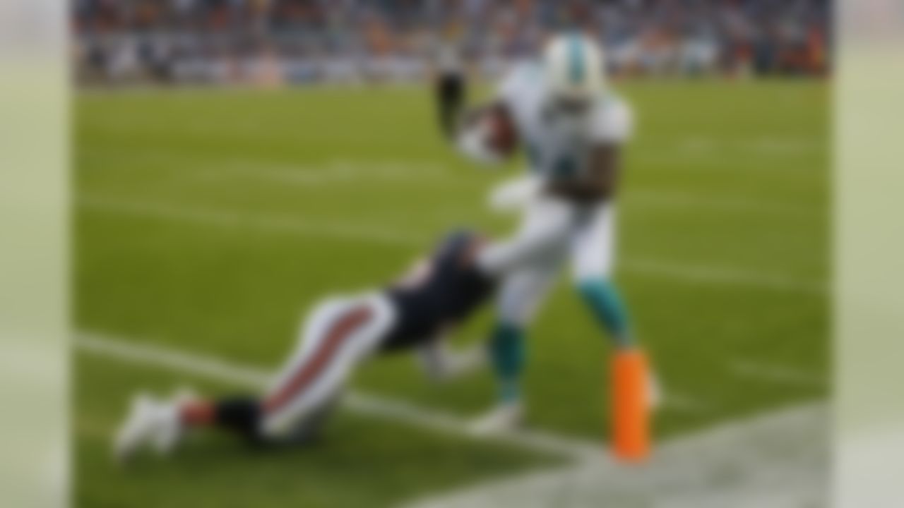 Miami Dolphins wide receiver Jarvis Landry (14) scores a touchdown as he's hoot by Chicago Bears free safety Brock Vereen (45) during the first half of an NFL preseason football game in Chicago, Thursday, Aug. 13, 2015. (AP Photo/Charles Rex Arbogast)