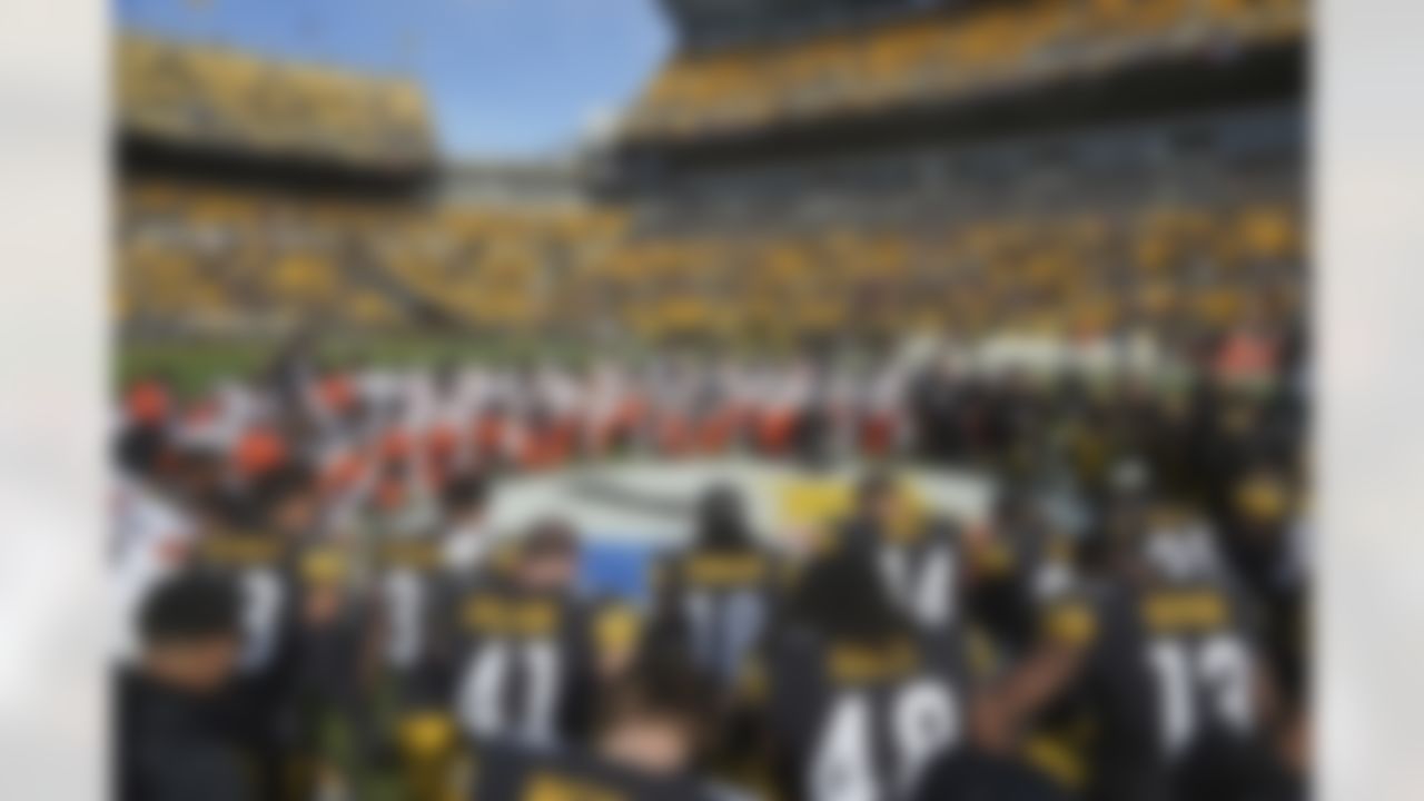 The Cleveland Browns and Pittsburgh Steelers kneel in prayer for injured Buffalo Bills safety Damar Hamlin before an NFL football game in Pittsburgh, Sunday, Jan. 8, 2023.