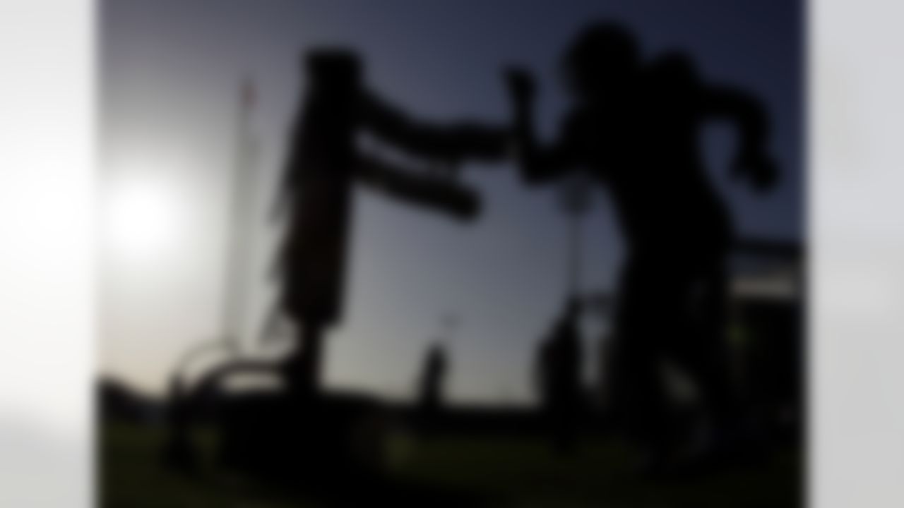 Houston Texans defensive tackle Amobi Okoye, right, hits a tackling dummy during NFL football training camp practice Sunday, Aug. 1, 2010, in Houston. (AP Photo/David J. Phillip)