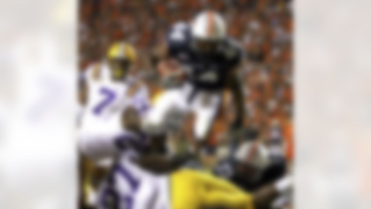 Auburn running back Ben Tate (44) dives over the top for a touchdown against LSU in the first half of an NCAA college football game in Auburn, Ala., on Saturday, Sept. 20, 2008. (AP Photo/Butch Dill)