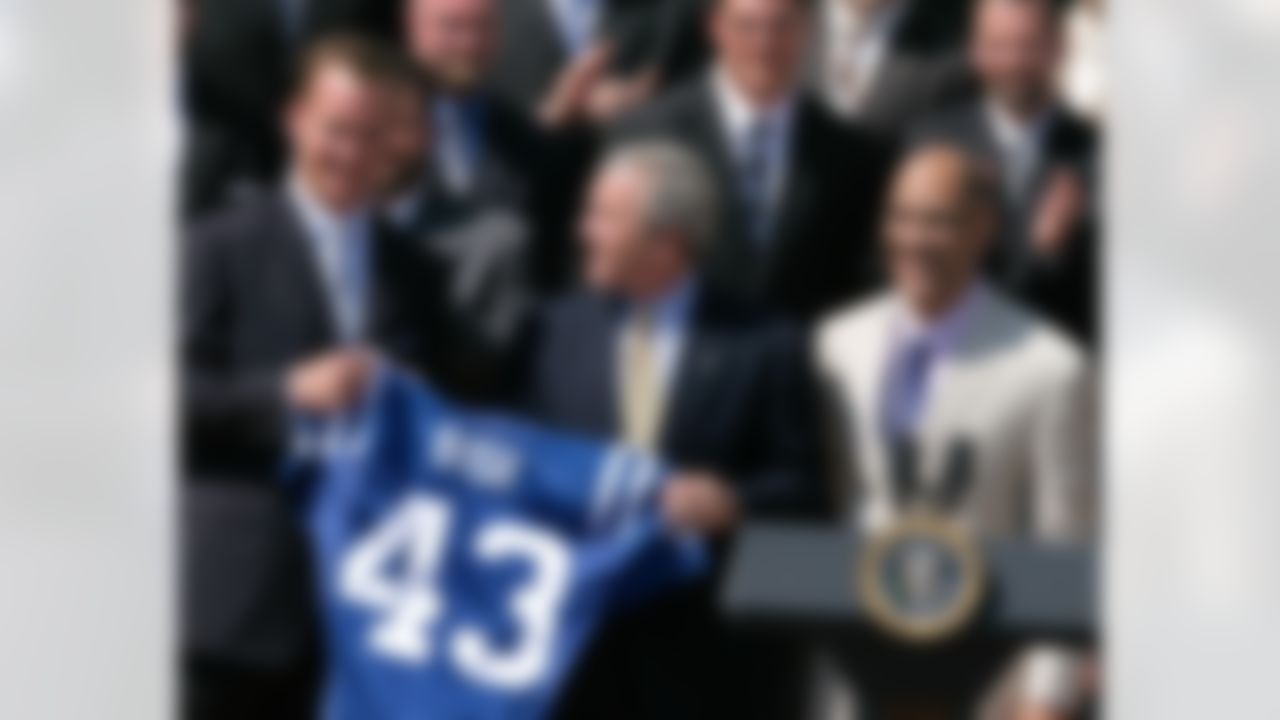 WASHINGTON - APRIL 23: U.S. President George W. Bush (C) is presented with a jersey from quarterback Peyton Manning (L) and Coach Tony Dungy of the Super Bowl champion Indianapolis Colts on the South Lawn at the White House April 23, 2007 in Washington, DC. The Colts won Super Bowl XLI last January beating the Chicago Bears 29-17. (Photo by Mark Wilson/Getty Images)
