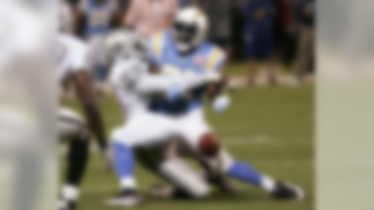 San Diego Chargers running back LaDainian Tomlinson, right, fumbles the ball and is brought down by Oakland Raiders defensive end Greg Ellis (99) during the first quarter of their NFL football game Monday, Sept. 14, 2009 in Oakland, Calif. The Raiders recovered the ball. (AP Photo/Paul Sakuma)