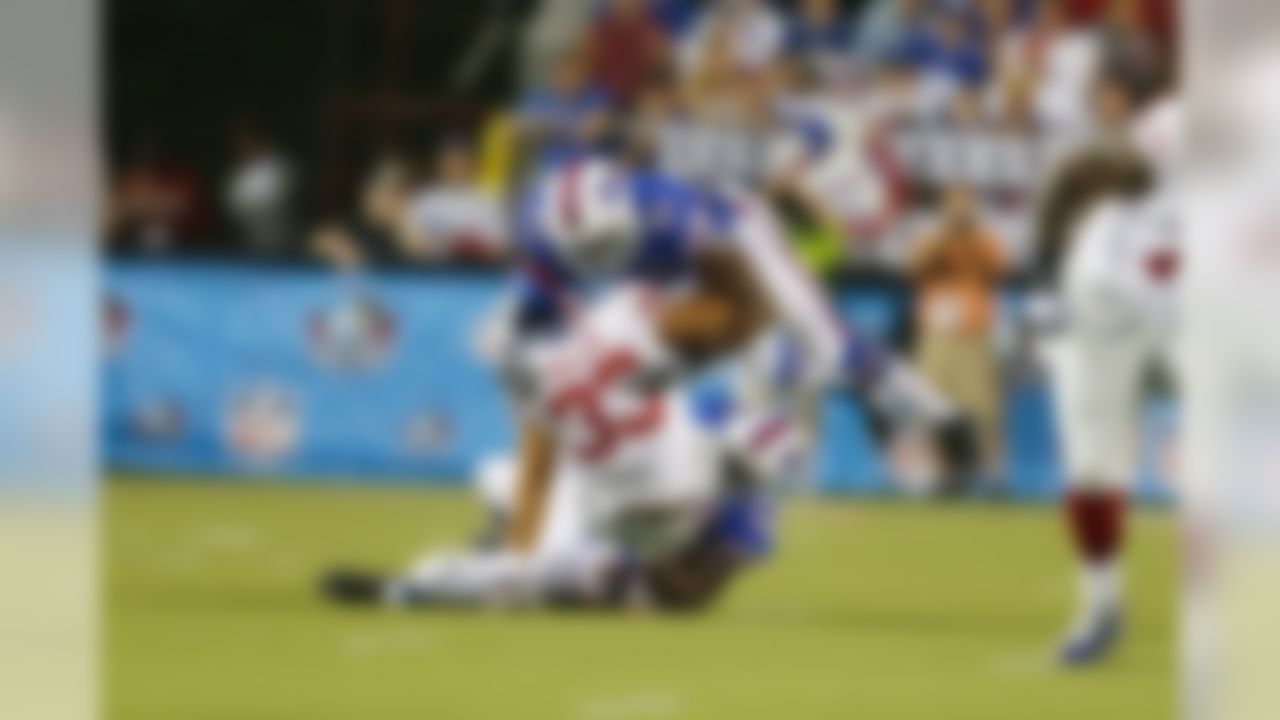 Buffalo Bills Manny Lawson tackles New York Giants Peyton Hillis during the 2014 Pro Football Hall of Fame game between the Buffalo Bills and New York Giants at Fawcett Stadium on Sunday, Aug. 3, 2014, in Canton, Ohio. (AP Photo/Ben Liebenberg)