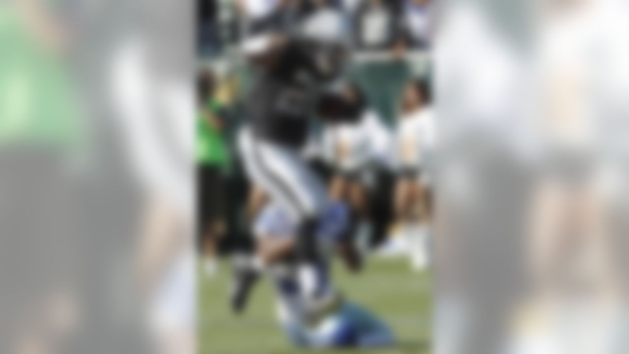 Oakland Raiders running back Darren McFadden (20) rushes against Dallas Cowboys defensive back Orlando Scandrick (32) during the first quarter of an NFL preseason football game in Oakland, Calif., Monday, Aug. 13, 2012. (AP Photo/Tony Avelar)