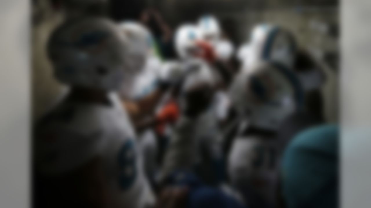 Members of the Miami Dolphins gather in the tunnel before an NFL football game against the San Diego Chargers, Sunday, Dec. 20, 2015, in San Diego. (AP Photo/Gregory Bull)