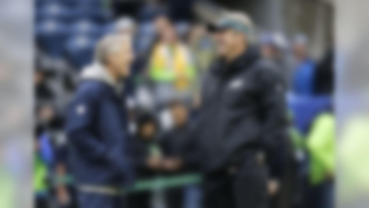 Seattle Seahawks head coach Pete Carroll, left, talks with Philadelphia Eagles head coach Doug Pederson, right, before an NFL football game, Sunday, Nov. 20, 2016, in Seattle. (AP Photo/Stephen Brashear)