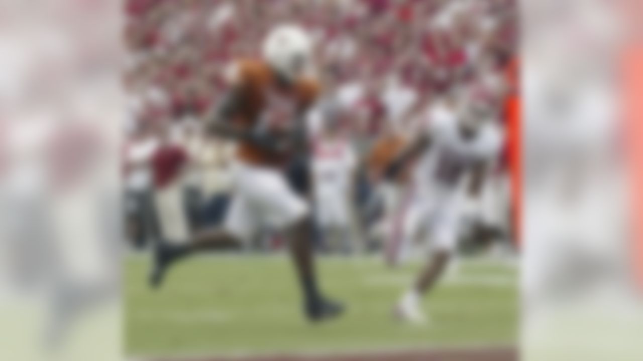 Texas tight end Jermichael Finley (16) runs with the ball on a 22-yard pass play against Oklahoma during the second quarter of a college football game against Oklahoma, Saturday, Oct. 6, 2007, in Dallas. Defending for Oklahoma is Oklahoma linebacker Lewis Baker (16).  (AP Photo/Tim Sharp)