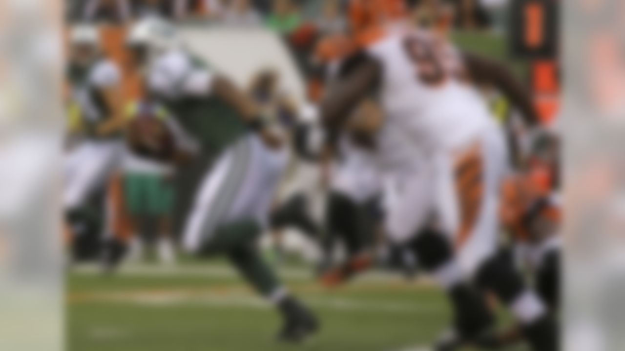 New York Jets quarterback Geno Smith (7) runs against the Cincinnati Bengals in the first half of an NFL preseason football game, Saturday, Aug. 16, 2014, in Cincinnati. (AP Photo/Tony Tribble)