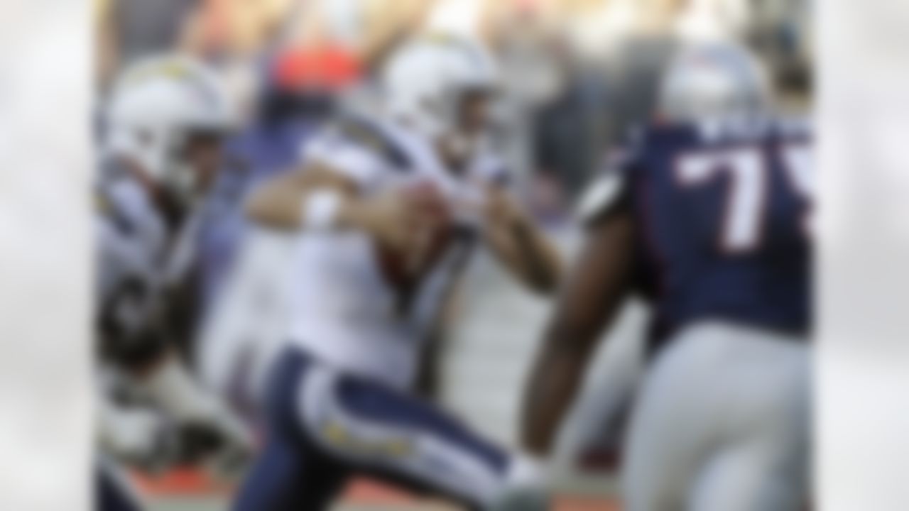 San Diego Chargers quarterback Philip Rivers (17)] scrambles on a keeper as guard Kris Dielman (68) tries to get to New England Patriots nose tackle Vince Wilfork (75) during the first half of an NFL football game in Foxborough, Mass., Sunday, Sept. 18, 2011. (AP Photo/Stephan Savoia)