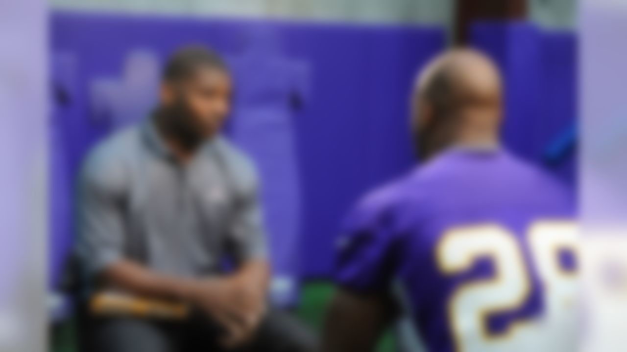 NFL Network's LaDainian Tomlinson, left,  interviews Minnesota Vikings running back Adrian Peterson at the Minnesota practice facility  in Eden Prairie, Minn., Wednesday, October 24, 2012. (AP Photo/Craig Lassig)