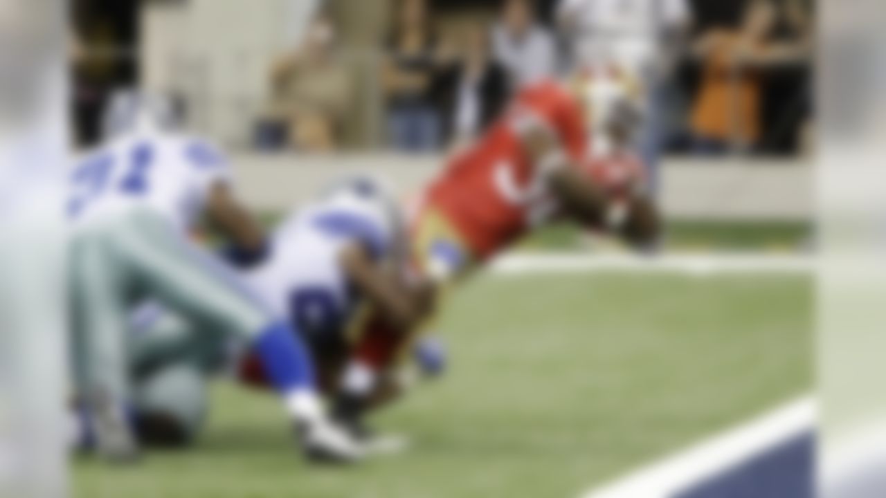 San Francisco 49ers running back Kory Sheets, front, leans forward to score a touchdown against the defense of Dallas Cowboys cornerback DeAngelo Smith (31) and cornerback Mike Mickens, center, in the second half of a preseason NFL football game  Saturday, Aug. 29, 2009, in Arlington, Texas. (AP Photo/LM Otero)