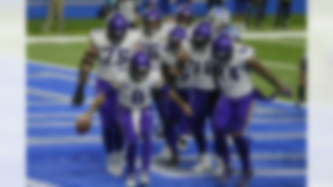 Minnesota Vikings quarterback Kirk Cousins (8) and teammates react after Cousins' touchdown during the second half of an NFL football game against the Detroit Lions, Sunday, Jan. 3, 2021, in Detroit.