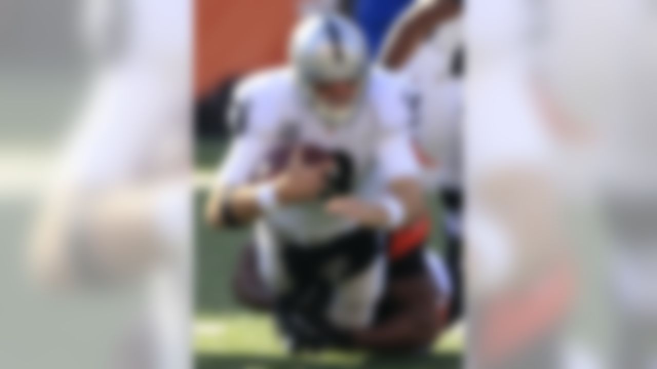 Oakland Raiders quarterback Carson Palmer (3) is sacked by Cincinnati Bengals defensive end Michael Johnson in the first half of an NFL football game, Sunday, Nov. 25, 2012, in Cincinnati. (AP Photo/Al Behrman)