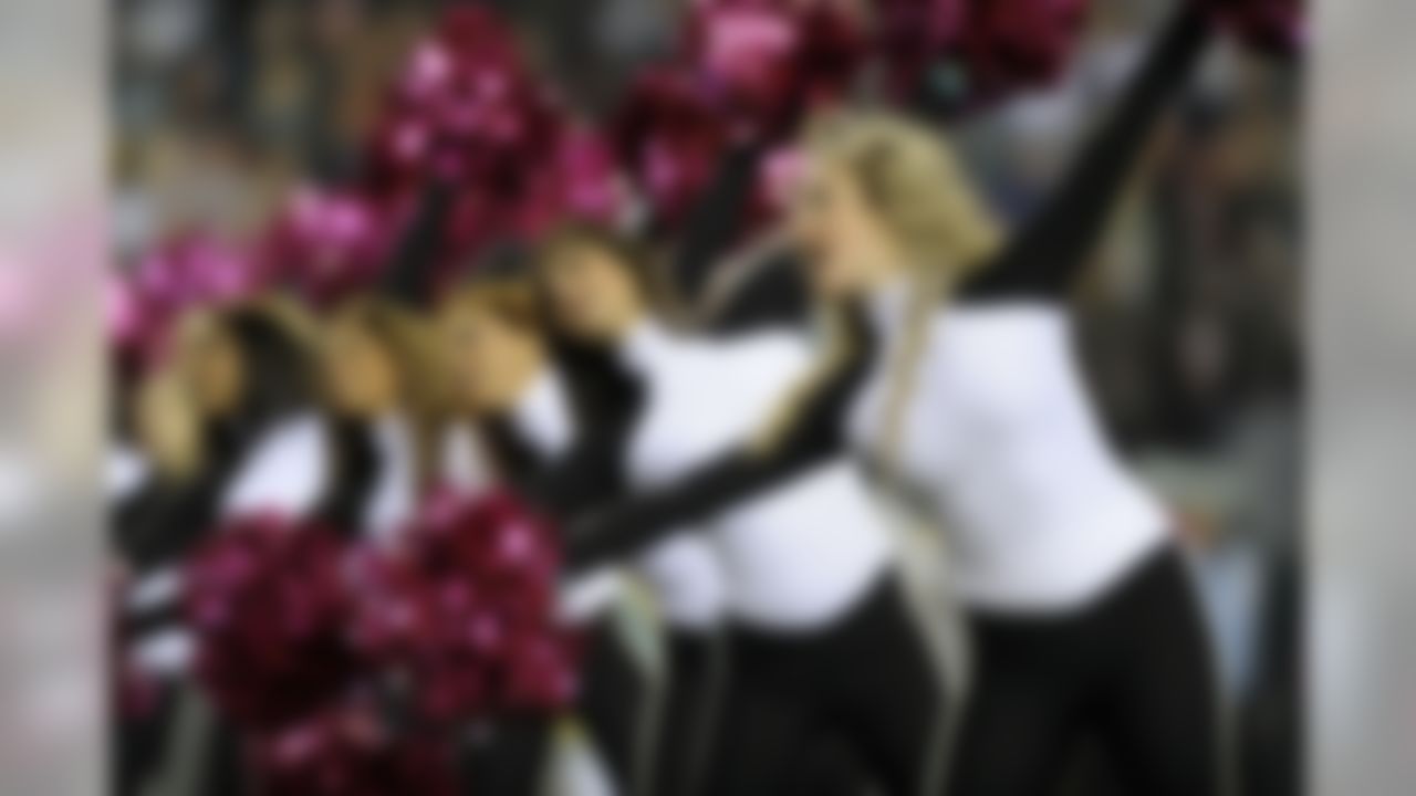 The Philadelphia Eagles cheerleaders use pink pom poms in the first half of an NFL football game with the Dallas Cowboys Sunday, Oct. 30, 2011 in Philadelphia. (AP Photo/Michael Perez)