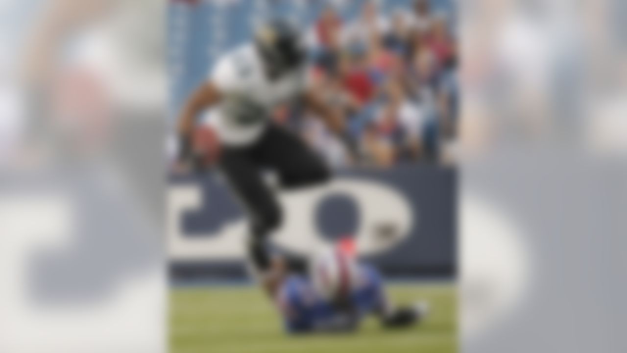 Jacksonville Jaguars' Rashad Jennings (23) jumps over Buffalo Bills' Nick Barnett (50) in the first quarter of an NFL preseason football game in Orchard Park, N.Y., Saturday, Aug. 27, 2011. (AP Photo/Derek Gee)