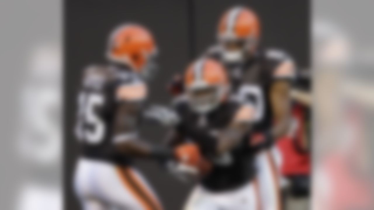 Cleveland Browns wide receiver Joshua Cribbs, center, is congratulated by teammates Greg Little (15) and Brian Robiskie (80) after catching a touchdown pass in the first quarter of a preseason NFL football game against the Green Bay Packers on Saturday, Aug. 13, 2011, in Cleveland.  (AP Photo/Tony Dejak)