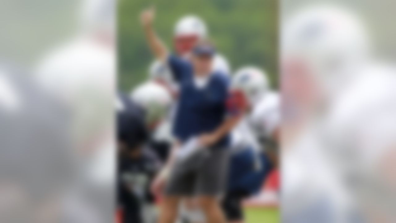 New England Patriots head coach Bill Belichick, center, signals the start of a scrimmage at NFL football training camp in Foxborough, Mass., Tuesday, Aug. 9, 2011. (AP Photo/Michael Dwyer)