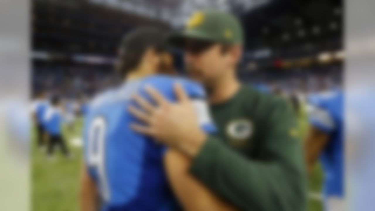 Detroit Lions quarterback Matthew Stafford (9) hugs Green Bay Packers quarterback Aaron Rodgers after an NFL football game at Ford Field in Detroit, Thursday, Nov. 28, 2013. The Lions won 40-10. (AP Photo/Paul Sancya)