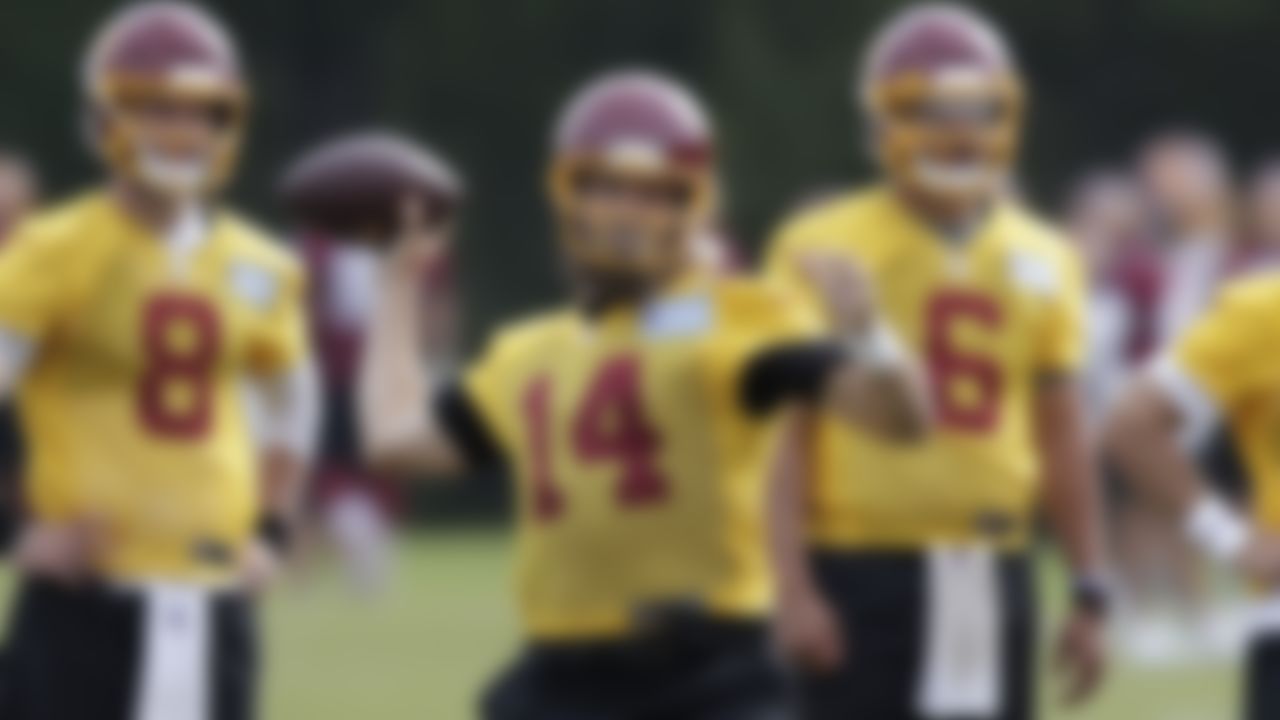 Washington Football Team quarterback Ryan Fitzpatrick (14) throws a pass as quarterbacks Kyle Allen (8), Steven Montez (6) and Taylor Heinicke (4) look on during an NFL football OTA at Inova Sports Performance Center in Ashburn, Va., Wednesday, June 2, 2021.