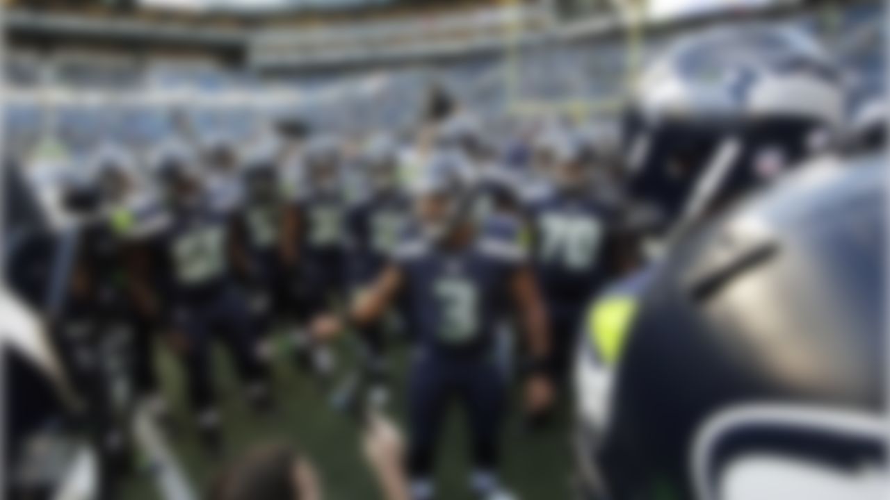 Seattle Seahawks quarterback Russell Wilson (3) leads his team in a huddle before a preseason NFL football game against the Oakland Raiders, Thursday, Sept. 3, 2015, in Seattle. (AP Photo/Elaine Thompson)