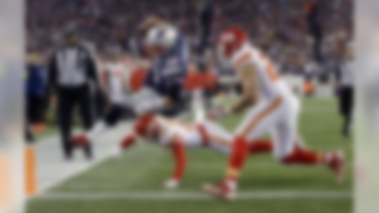 Kansas City Chiefs free safety Husain Abdullah (39) pushes New England Patriots quarterback Tom Brady (12) out of bounds short of the goal line in the first half of an NFL divisional playoff football game, Saturday, Jan. 16, 2016, in Foxborough, Mass. (AP Photo/Steven Senne)