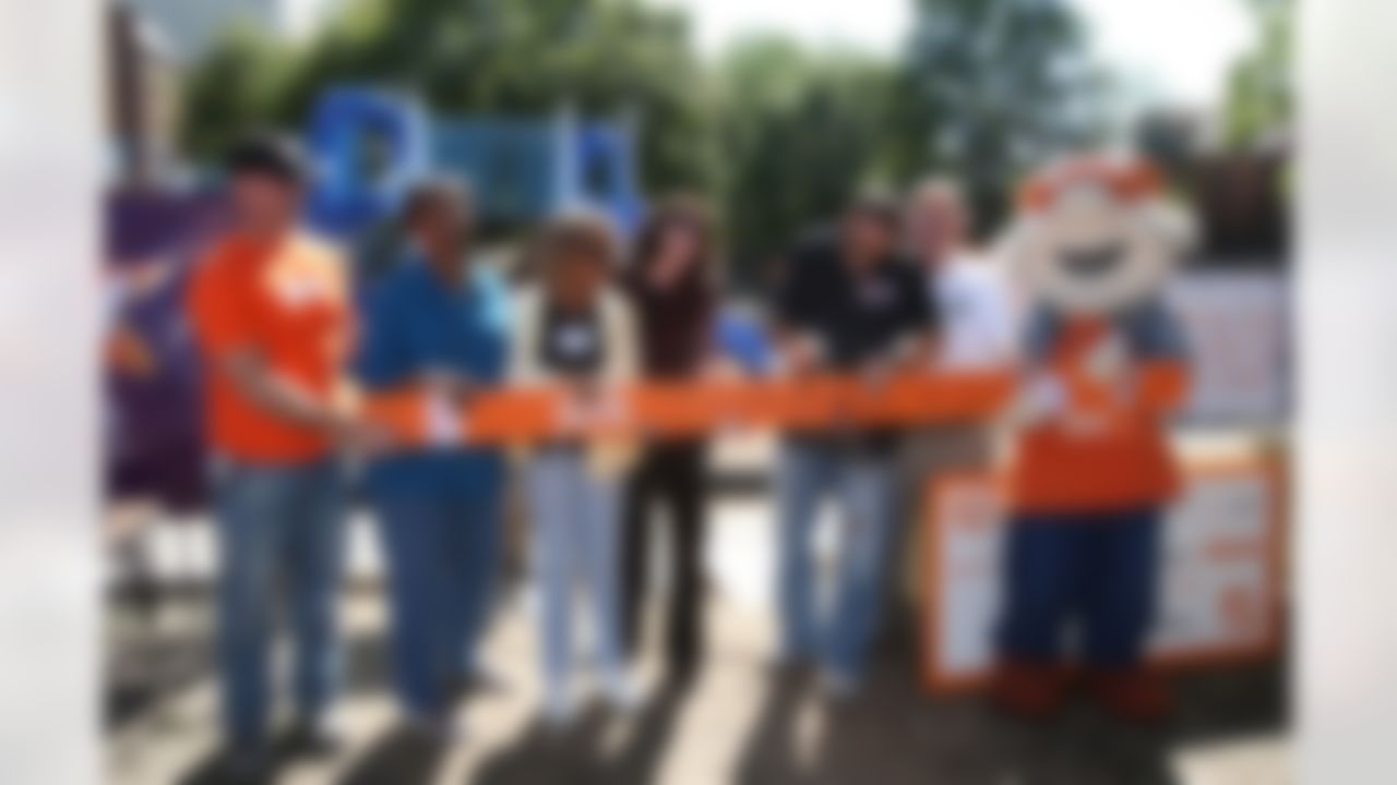 Mike Furrey and representatives from The Home Depot, KaBOOM! and Jop Preparatory Academy participate in the ceremonial board cutting. (Photo by Tom Copeland/Home Depot)