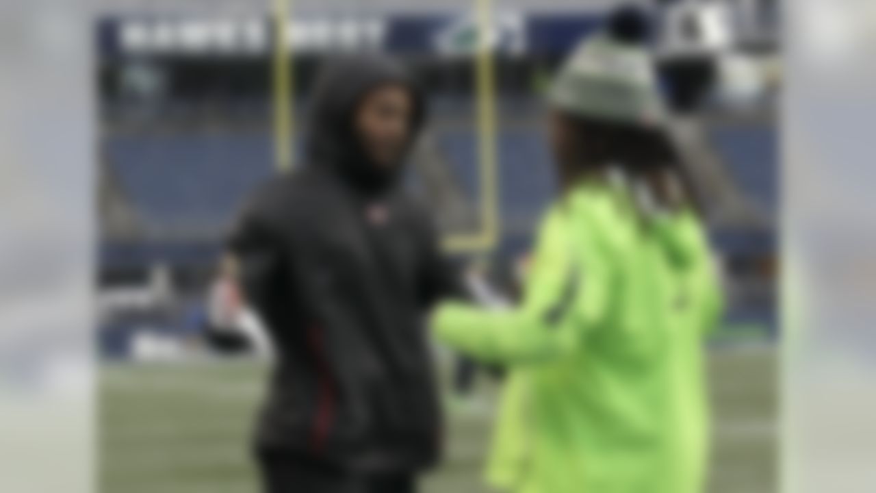 San Francisco 49ers cornerback Richard Sherman, left, greets Seattle Seahawks outside linebacker Shaquem Griffin during warmups before an NFL football game, Sunday, Dec. 2, 2018, in Seattle. (AP Photo/John Froschauer)