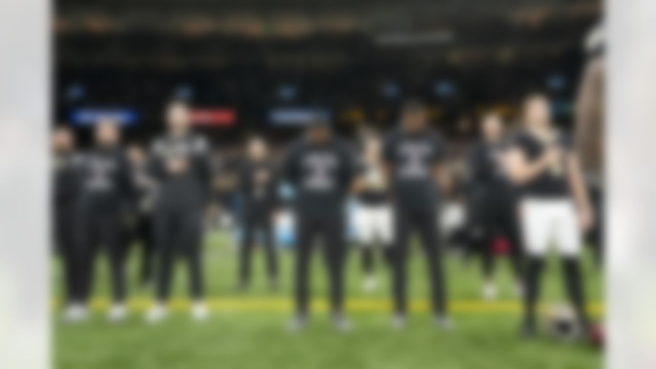 Members New Orleans Saints stand during the national anthem wearing a T-shirts in support of Buffalo Bills player Damar Hamlin before an NFL football game between the Carolina Panthers and the New Orleans Saints in New Orleans, Sunday, Jan. 8, 2023.