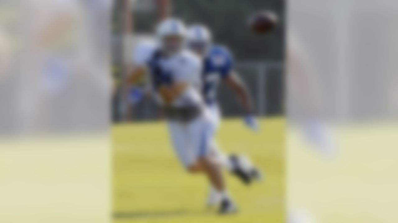 Indianapolis Colts wide receiver Anthony Gonzalez looks to make a catch in front of defensive back Jacob Lacey during the NFL team's football training camp in Anderson, Ind., Monday, Aug. 8, 2011.  (AP Photo/Michael Conroy)